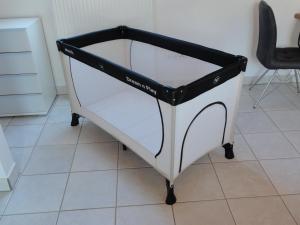 a white and black cart sitting on a tile floor at Ferienwohnung Sylvianne in Ottenhöfen +17 photos