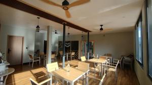 a dining room with tables and chairs and a ceiling at Madi Grand Maldives in Fulidhoo