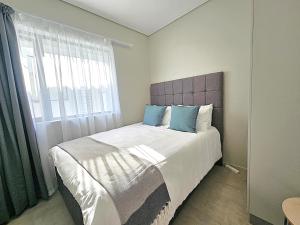 a bedroom with a large bed with a window at Bella Mare 12 on Second in Gqeberha +35 photos