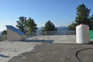 a white tank sitting on the side of a patio at Riasat Home Stay - Nathia Gali Road in Bāzār