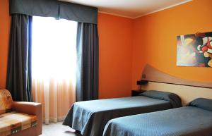 um quarto com 2 camas e uma janela em Hotel Del Sole em Pastorano