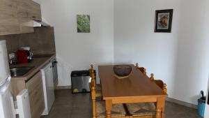 a small kitchen with a wooden table and a sink at Appartement Porto - Ota in Porto Ota +13 photos