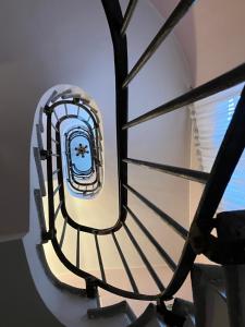 a spiral staircase in a building with a window at Hotel Saini with Air conditioning in Stresa