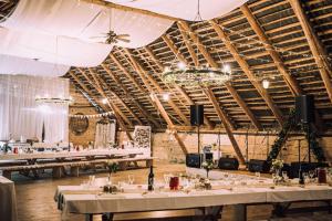 a banquet hall with tables set up for a wedding at Pinska Guesthouse in Pinska