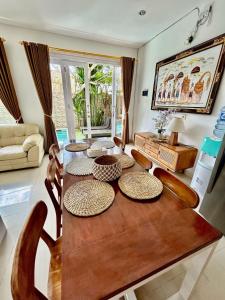 a living room with a wooden table and chairs at Villa Velia 3BR with private pool in Badung