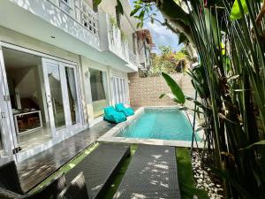 a swimming pool in front of a house at Villa VELIA private pool in Badung