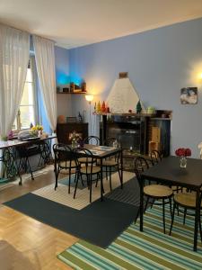 a dining room with tables and chairs and a fireplace at Hotel Saini with Air conditioning in Stresa