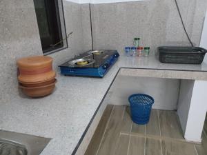 a kitchen counter with a stove and a sink at Lily Cabana in Galle