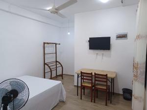 a room with a bed and a table and chairs at Lily Cabana in Galle