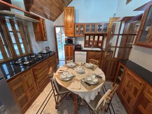 a kitchen with a table with dishes on it at Silverstone Mansions Cottages in Manāli