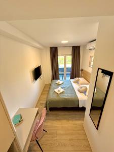 a hotel room with a bed and a mirror at Cloud9 Airport Rooms in Močići