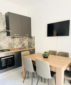 a dining room with a wooden table and chairs at GioGio house in Vico Equense