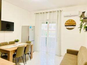 a kitchen and dining room with a table and chairs at GioGio house in Vico Equense