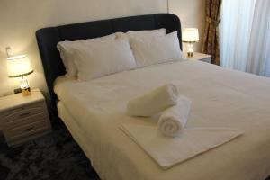 a bed with a pile of towels on it at Ajman for families in Ajman 