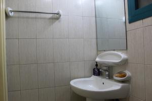 a bathroom with a white sink and a mirror at Ajman for families in Ajman  +12 photos