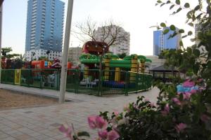a playground in a park with a water slide at Ajman for families in Ajman 