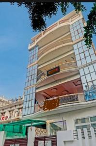 a tall building with a lot of windows on it at Hotel Relax Inn in Utrāhtia