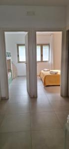 a bedroom with a bed and an open doorway at Appartamento Miele in Zambrone +32 photos