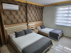 a hotel room with two beds and a window at ANTALYA Konyaaltı Gündüz Otel in Antalya +42 photos