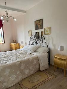 a bedroom with a large bed with a white bedspread at La dimora Poliziana di Anna in Montepulciano