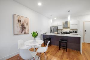 a kitchen with a table and chairs and a table and a counter at Luxury 1br Nolibs Pool Access in Philadelphia