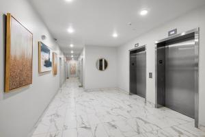 a hallway with two doors and a tile floor at Luxury 1br Nolibs Pool Access in Philadelphia