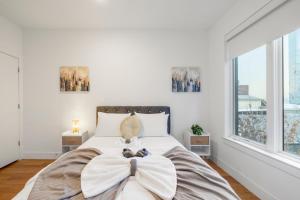 a bedroom with a large bed with a bow on it at Luxury 1br Nolibs Pool Access in Philadelphia