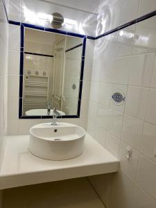 a white bathroom with a sink and a mirror at Villa Porto vecchio vue mer 5 étoiles piscine parking privé gratuit in Porto-Vecchio +17 photos