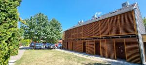 a building with wooden shutters on the side of it at EL PASO chata B1 - B5 v areáli kúpaliska in Štúrovo