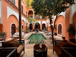 a courtyard with a swimming pool in a building at Riad Amina in Marrakesh