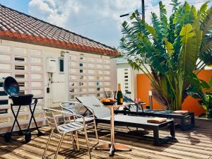 a patio with a table and chairs on a deck at Villa M Ryukyu Traditional House Yumata in Miyako Island