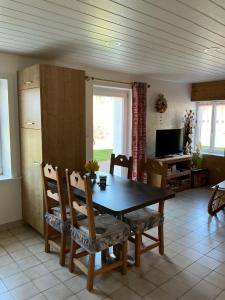 a kitchen with a dining room table and chairs at LES CŒURS DU TILLEUL in Gérardmer +13 photos