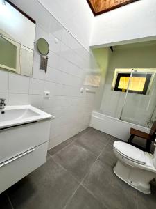 a bathroom with a toilet and a sink and a tub at Solar do Maranhão in Capelas +16 photos