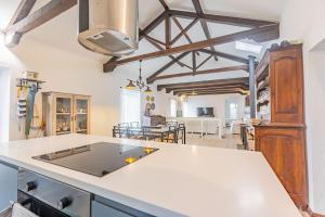 a kitchen with white countertops and a dining room at Solar do Maranhão in Capelas