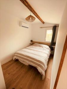 a bedroom with a bed in the corner of a room at Emeric & Julie Lou Pescalune classé 3 étoiles in Lunel