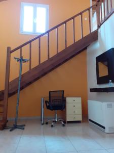 a room with a chair and a staircase at Castelo Chalet Chios in Chios