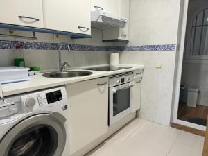 a kitchen with a sink and a washing machine at Cozy Sunset in Almerimar