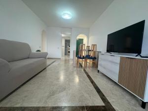 a living room with a couch and a flat screen tv at Cozy Sunset in Almerimar +7 photos