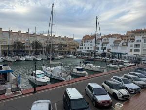 a group of cars parked in a marina with boats at Cozy Sunset in Almerimar