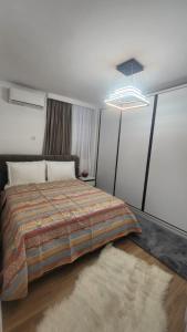 a bedroom with a large bed with a rug at Alcatraz Apartment Durres in Durrës +27 photos