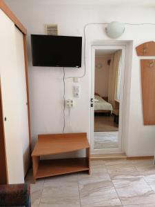 a living room with a flat screen tv on a wall at Стаи за гости" Герови" in Nesebar