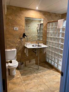 a bathroom with a sink and a toilet at Rallye Hotel in L'Escala