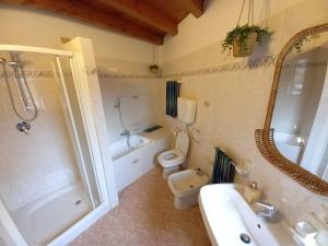 a bathroom with a toilet and a shower and a sink at Casa FiorElena in Gargnano +43 photos