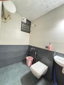 a bathroom with a toilet and a sink at Laasya Haven in Mangalore +20 photos