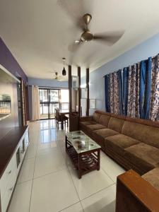 a living room with a couch and a table at Laasya Haven in Mangalore