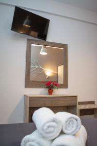 two towels on a table in front of a mirror at Azzurro in Nei Poroi