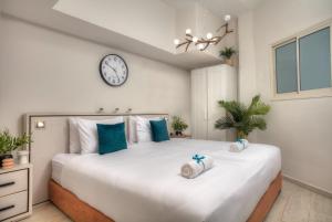 a bedroom with a large bed with a clock on the wall at Ruth's Suites - סוויטות רות - 2 in Safed