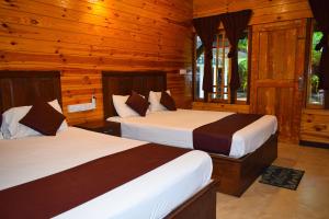 Katil atau katil-katil dalam bilik di Elvis Beach Resort