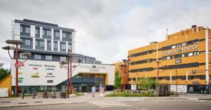 a city with two buildings and a street at Bedroom in apartment 12 minutes to Oslo City by train in Oslo