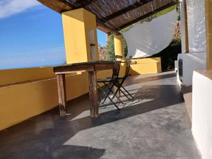 a table on the balcony of a house at Casa al Vallone in Alicudi +9 photos